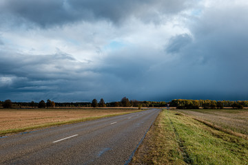 storm clouds over asphalt road in perspective