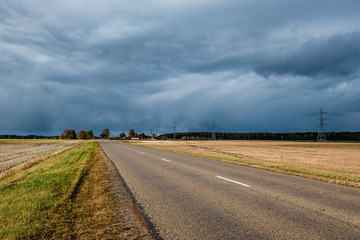 storm clouds over asphalt road in perspective