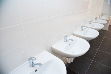 Close-up of row modern ceramic wash hand basins