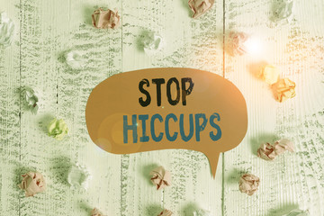 Conceptual hand writing showing Stop Hiccups. Concept meaning get rid of the involuntary spasm of the diaphragm muscles Colored speech bubble paper balls wooden rustic vintage background