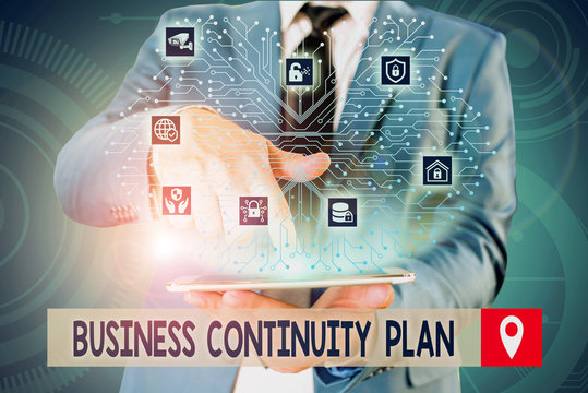 Handwriting text writing Business Continuity Plan. Conceptual photo creating systems prevention deal potential threats Male human wear formal work suit presenting presentation using smart device