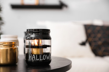 Burning candles on table in room. Idea for Halloween interior