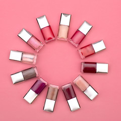 Obraz premium nail polishes of different colors are built on a pink background concept flat lay
