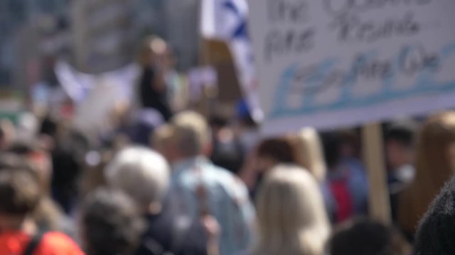 Blurred crowd of protester marching on the street.