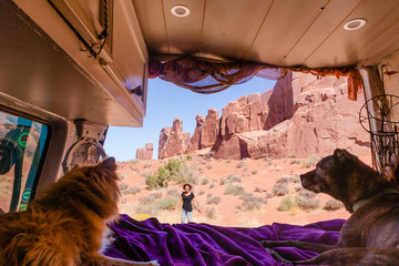View out the back of camper van with women enjoying site