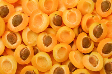Ripe juicy orange apricots slices fruit background.