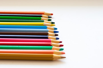 Row of colorful pencils are lying on white background. Preparing to school, university, college, background with  copy space