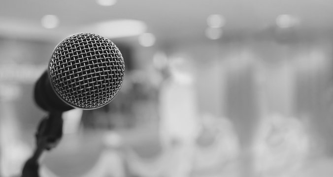 Microphone over the Abstract blurred photo of conference hall or seminar room background , panorama