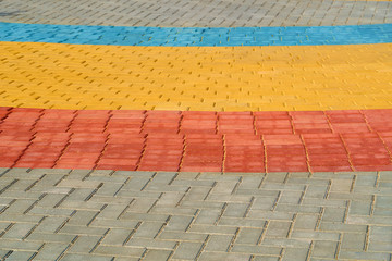 yellow, red and blue paving tiles for background or texture