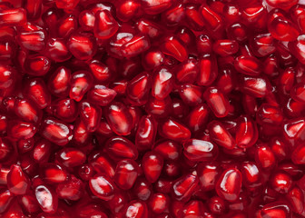 red fresh pomegranate seeds background