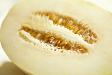 Variegated Snow Leopard Honeydew Melon aka Ivory Gaya or Sweet Snowball cut open showing seeds