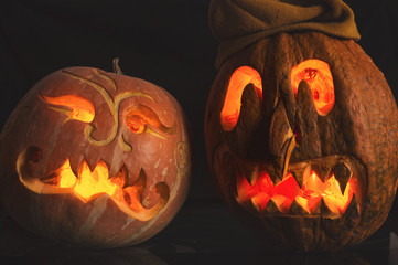 Carved from a pumpkin funny and grim masks. Still life with fresh ripe gourd for Halloween. Autumn...