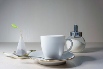 On a light table is a white cup of fruit tea.