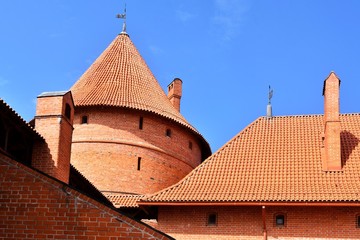 Lithuania, Vilnius - July 2019. Trakai castle medieval gothic Island castle, located in Galve lake. most of beautiful and popular Lithuanian landmark. Defensive fortress with a red tiled roof   © Tetiana Ivanova