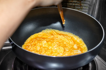 Egg Omelette Cooking in a Coated Frying Pan.