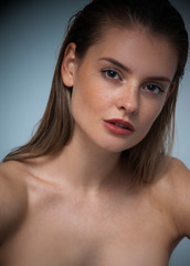 Naklejka premium portrait of fashion model beautiful girl with freckles in studio, close up, beautiful girl young woman