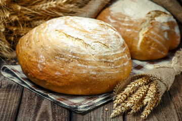 loaf of bread on wooden background, food closeup.Fresh homemade bread.French bread. Bread at leaven. Unleavened bread.Ciabatta bread.