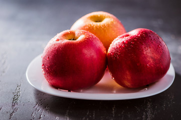 Apples red. Close-up of an apple. Water spray droplets.
