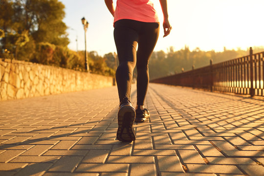 Rear View Of A Runner Walking On A Road In A Park