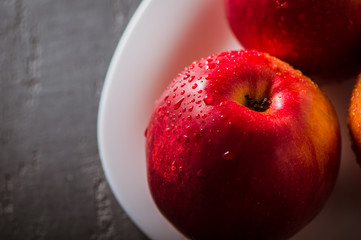 Apple red. Close-up of an apple. Water spray droplets.