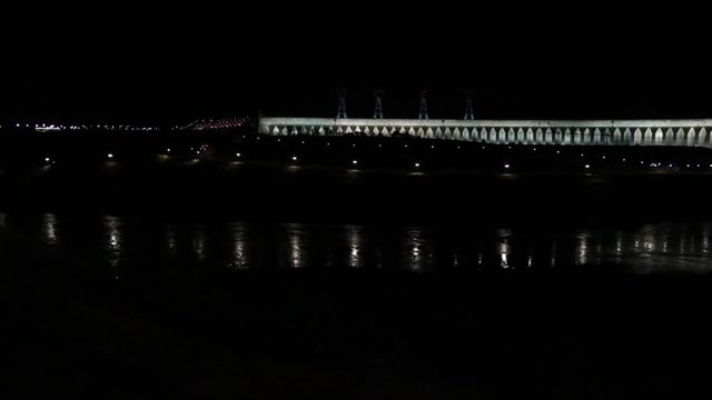 View of the illuminated Itaipu Dam at night. The biggest hydroelectric dam on the Parana River located between Brazil and Paraguay.