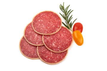 Salami sliced. Raw smoked sausage slices with herbs, isolated on white background