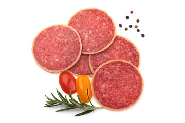 Salami sliced. Raw smoked sausage slices with herbs, isolated on white background
