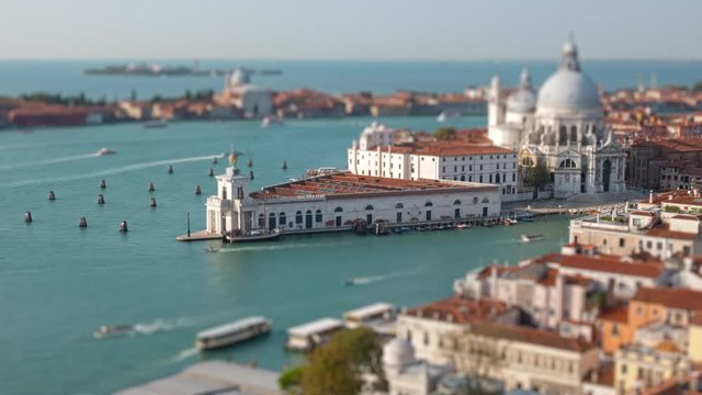 Aerial tilt shift hyper lapse of Grand Canal traffic and Basilica di Santa Maria della Salute, view from Campanile, Venice, Italy
