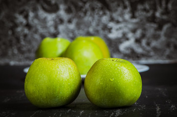 Fototapeta na wymiar Green fresh apples on the table, cut.