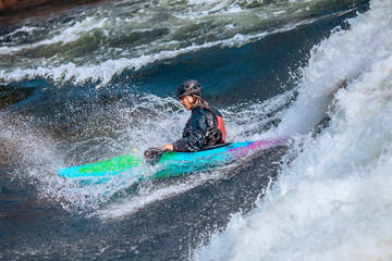 Fototapeta na wymiar Whitewater kayaking, extreme sport rafting. Guy in kayak sails mountain river