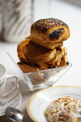 Tea time. Rusks and croissants with poppy seeds in a glass vase.