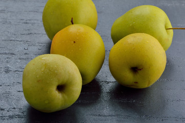 Fresh yellow apples. Wash apples in water.