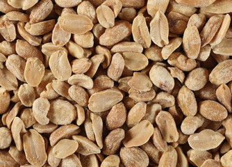 Salted and marinated peanuts background and texture