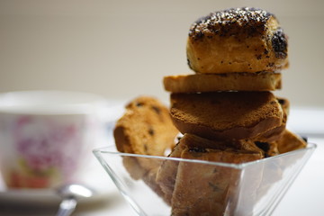 Rolls with poppy seeds. Sweet cookies in glass vase close up.