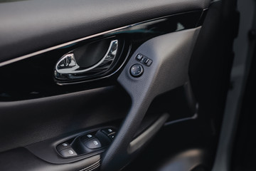 Obraz na płótnie Canvas Control panel in the car door. Car door handle with adjustment knobs.