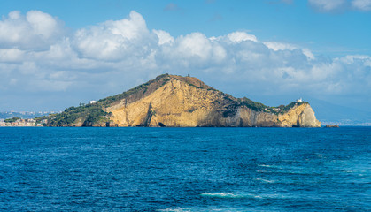 Miseno Cape with lighthouse as seen from the ferry to Procida. Naples, Campania, Italy.