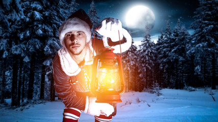 Young elf with red lamp and magic christmas night. 