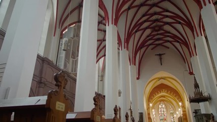 Christian Catholic St. Thomas Church (Thomaskirche) interior in Leipzig, Germany, Europe. Remains of Johann Sebastian Bach are here. 4K Background Panning Low Angle Indoors Shot
