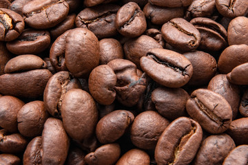 Brown coffee beans background texture, close-up.