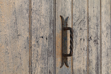Old iron rusty handle on wooden doors