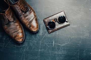 leather accessories shoes, passport glasses. The concept of things on a journey.