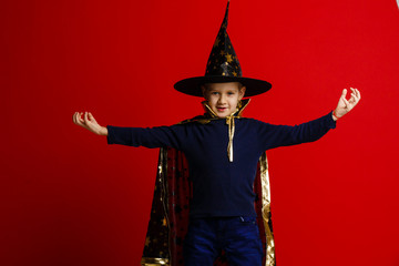 boy dressed as a wizard on a red background