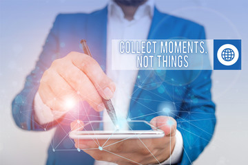 Conceptual hand writing showing Collect Moments Not Things. Concept meaning Happiness philosophy enjoy simple life facts Male human wear formal suit presenting using smart device