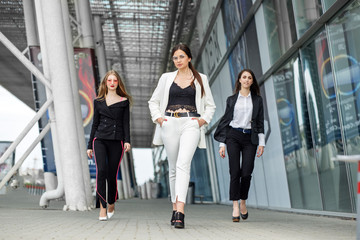 Three successful young women. Concept for business, boss, work and success.