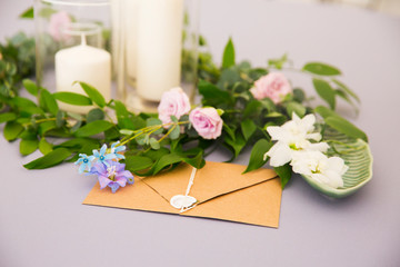 Beautiful decorations on the table. Brunch with pink rose, gift, letter