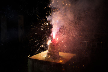 Festive cake with fireworks on the table at night. Cake on dark background
