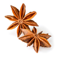Star anise spice. Two dry star anise fruits isolated on white background. Macro close-up top view of illicium verum or chinese badiane.