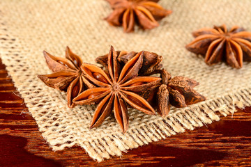 Star anise. Some star anise fruits. Macro close-up on the jute burlap napkin in rustic style.