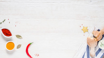 Culinary class. Flat lay of fresh crusty homemade bread and colorful spices on white wooden background. Copy space.