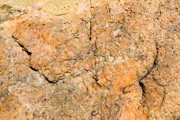 Ancient granite wall background and texture, close-up.